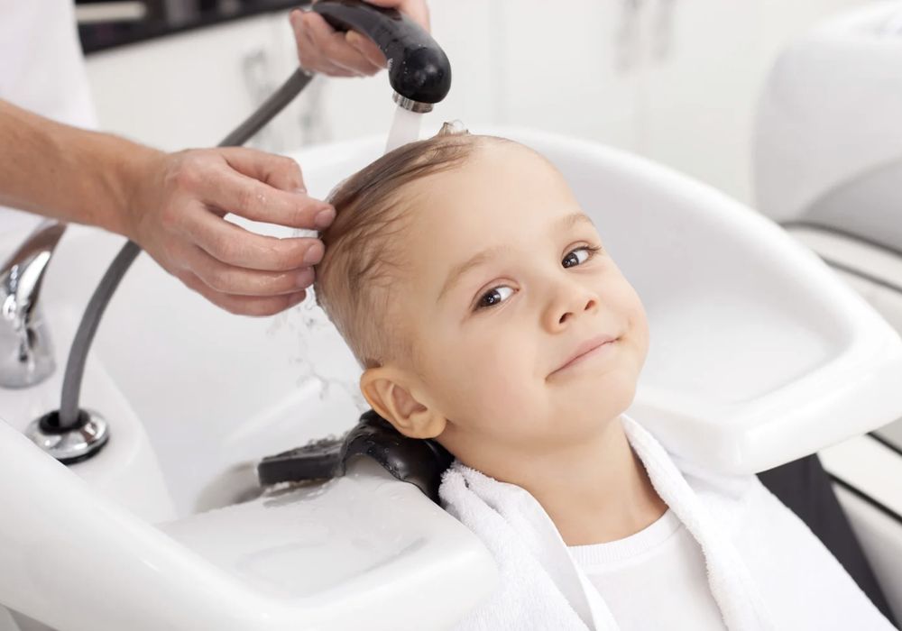 A child enjoying a gentle hair wash at the salon