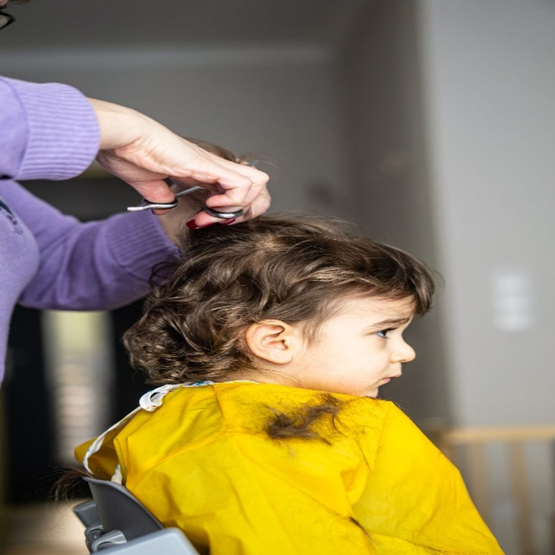 A young child having a gentle haircut at Cuddle Kutz